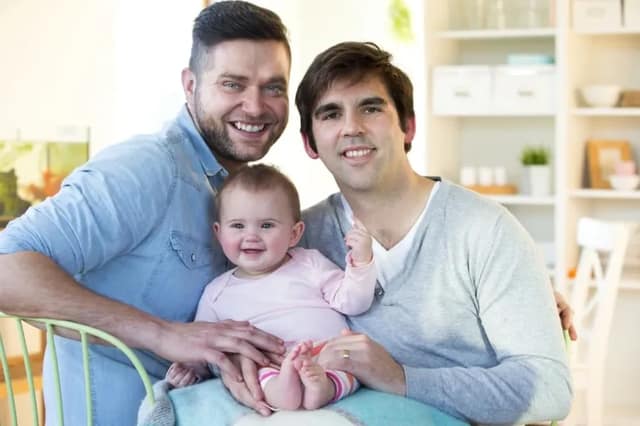 Couple de pères avec leur bébé illustrant l’homoparentalité