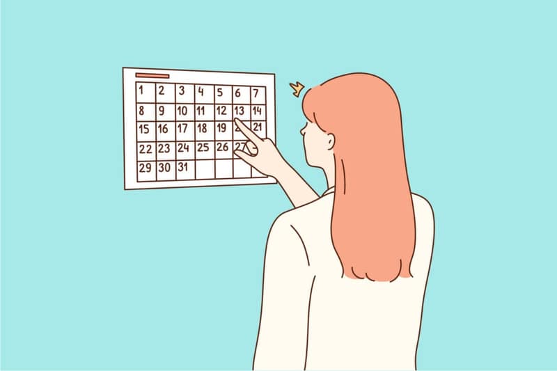 Femme qui lit un calendrier date des règles