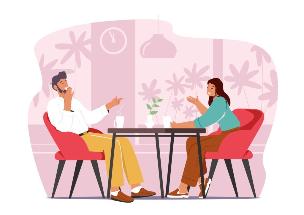 jeune couple heureux assis table discutent